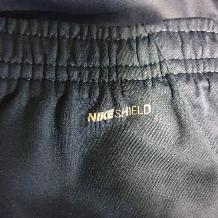 [BUNJANG] Nike Shield Solo Swoosh Woven Jogger Pants (Navy, M) / 나이키 쉴드 솔로스우시 밑단집업 우븐 조거팬츠 네이비 (M)