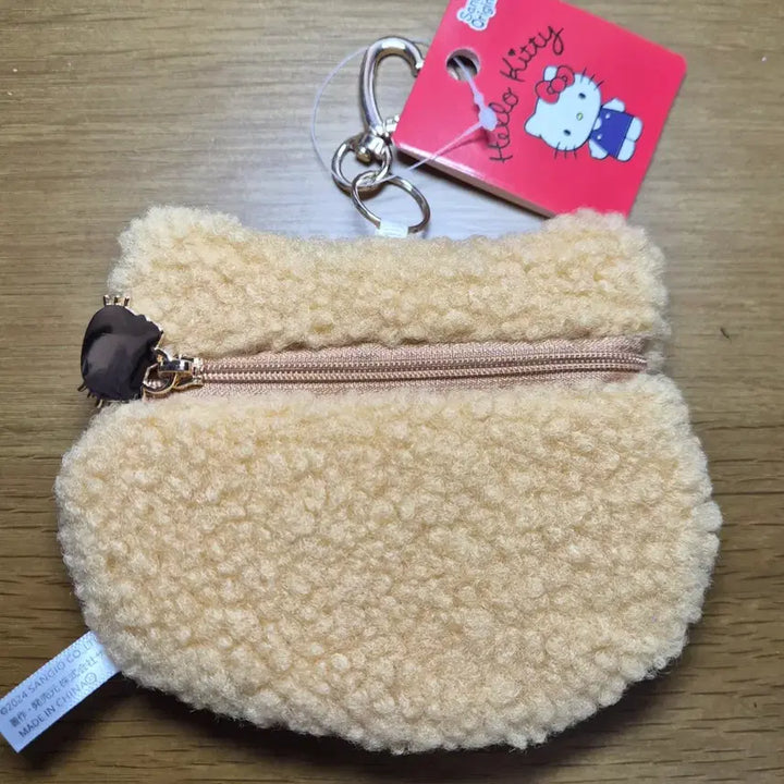 [BUNJANG] Sanrio Hello Kitty "Poonggi" Pouch Coin Purse with Keychain / 산리오 헬로키티 얼굴 뽀글이 파우치 동전지갑 키링/ 태닝키티