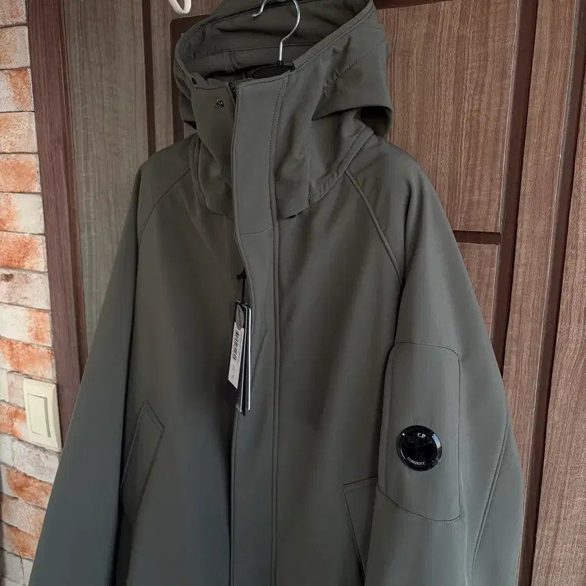[BUNJANG] CP Company Lens Logo Hooded Long Jacket Khaki / [새상품]CP컴퍼니 씨피컴퍼니 렌즈 로고 후드 롱 자켓 카키