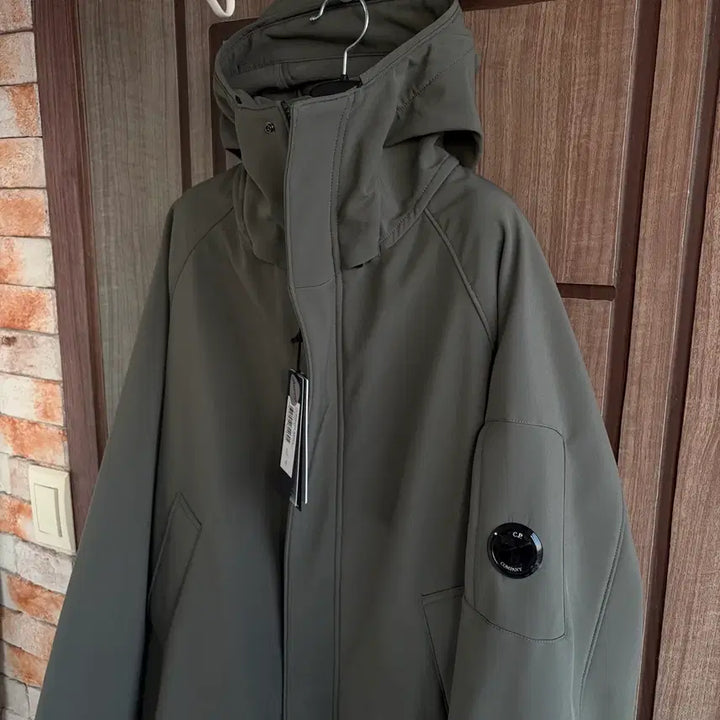 [BUNJANG] CP Company Lens Logo Hooded Long Jacket Khaki / [새상품]CP컴퍼니 씨피컴퍼니 렌즈 로고 후드 롱 자켓 카키