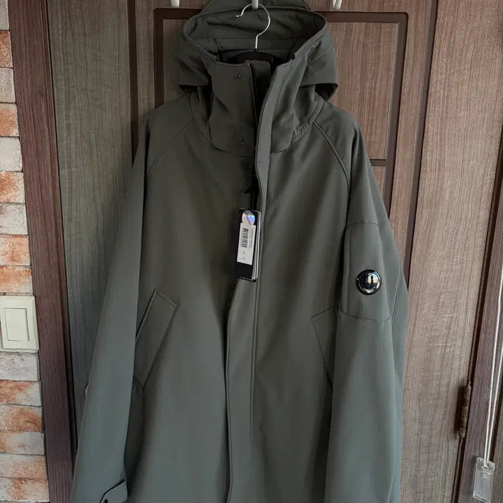 [BUNJANG] CP Company Lens Logo Hooded Long Jacket Khaki / [새상품]CP컴퍼니 씨피컴퍼니 렌즈 로고 후드 롱 자켓 카키